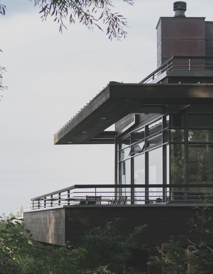 A contemporary house with glass windows and balcony design located in Toronto, Canada.