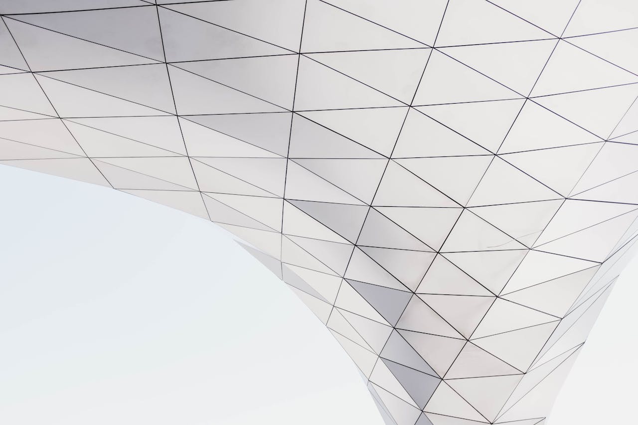 Low angle view of a modern geometric architectural structure with triangle patterns.